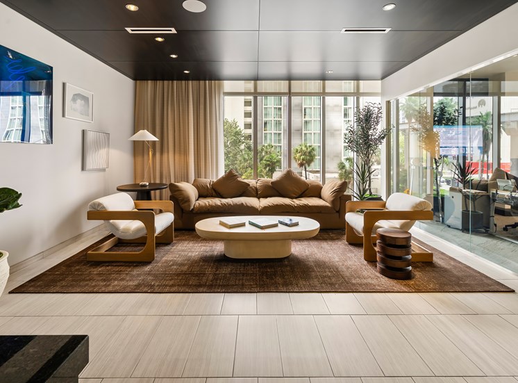 A modern living room with a large sectional sofa and a coffee table.